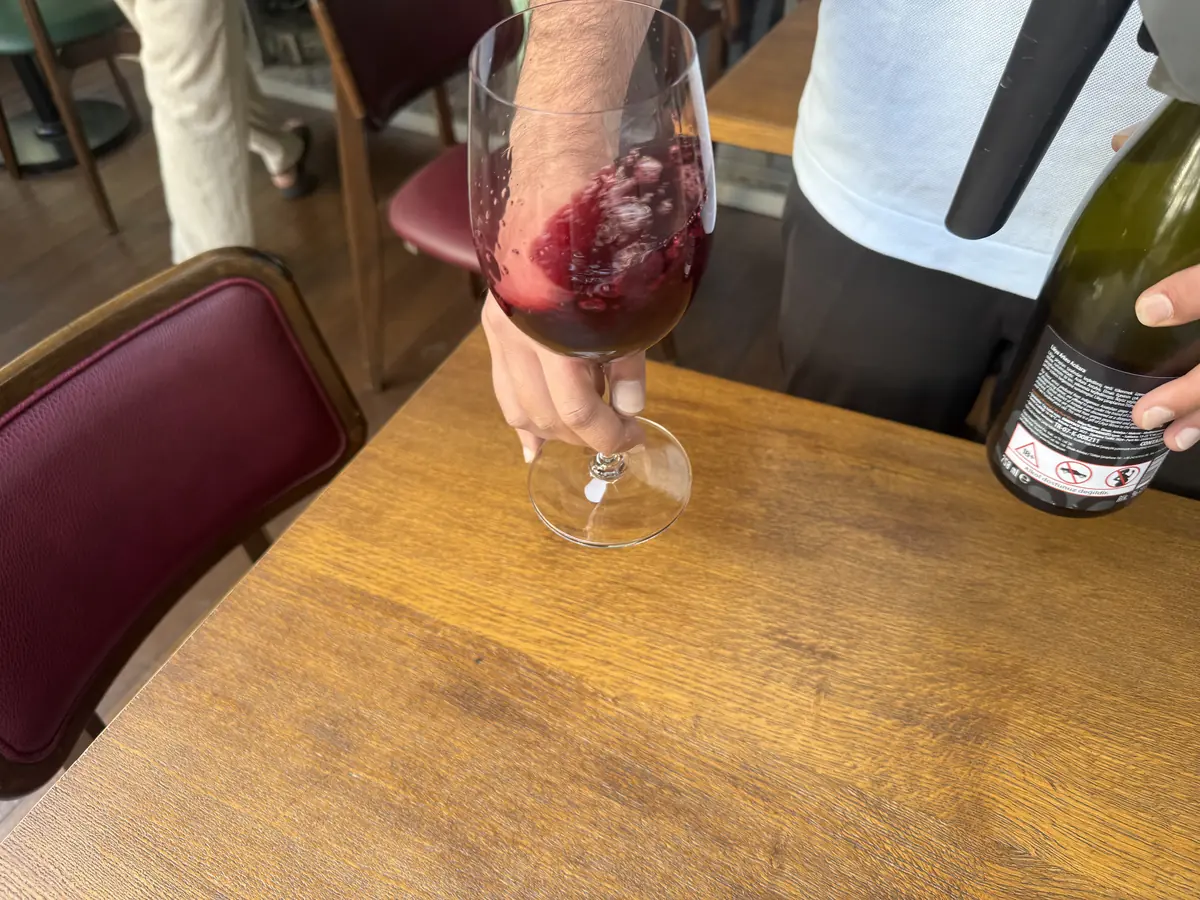 Turkish red wine swirling into a glass from a Coravin pour at WAYANA Wine Bar