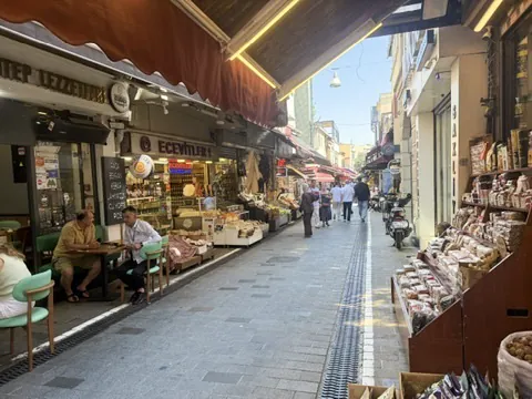 Narrow market street in Kadıköy with fish restaurants and shop displays either side