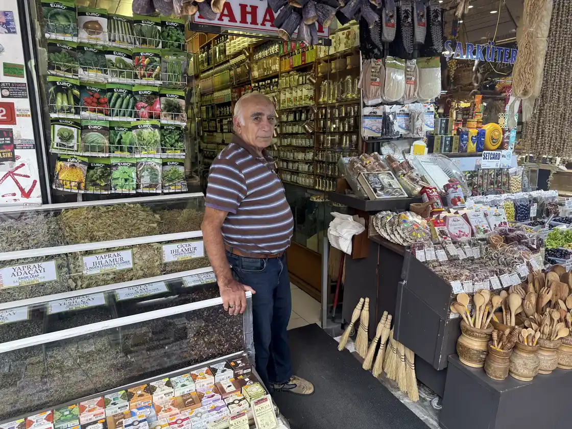 Herbalist among sacks of dried roses, hibiscus, spices and teas in his Kadıköy Market shop — the raw materials of Ottoman sherbets