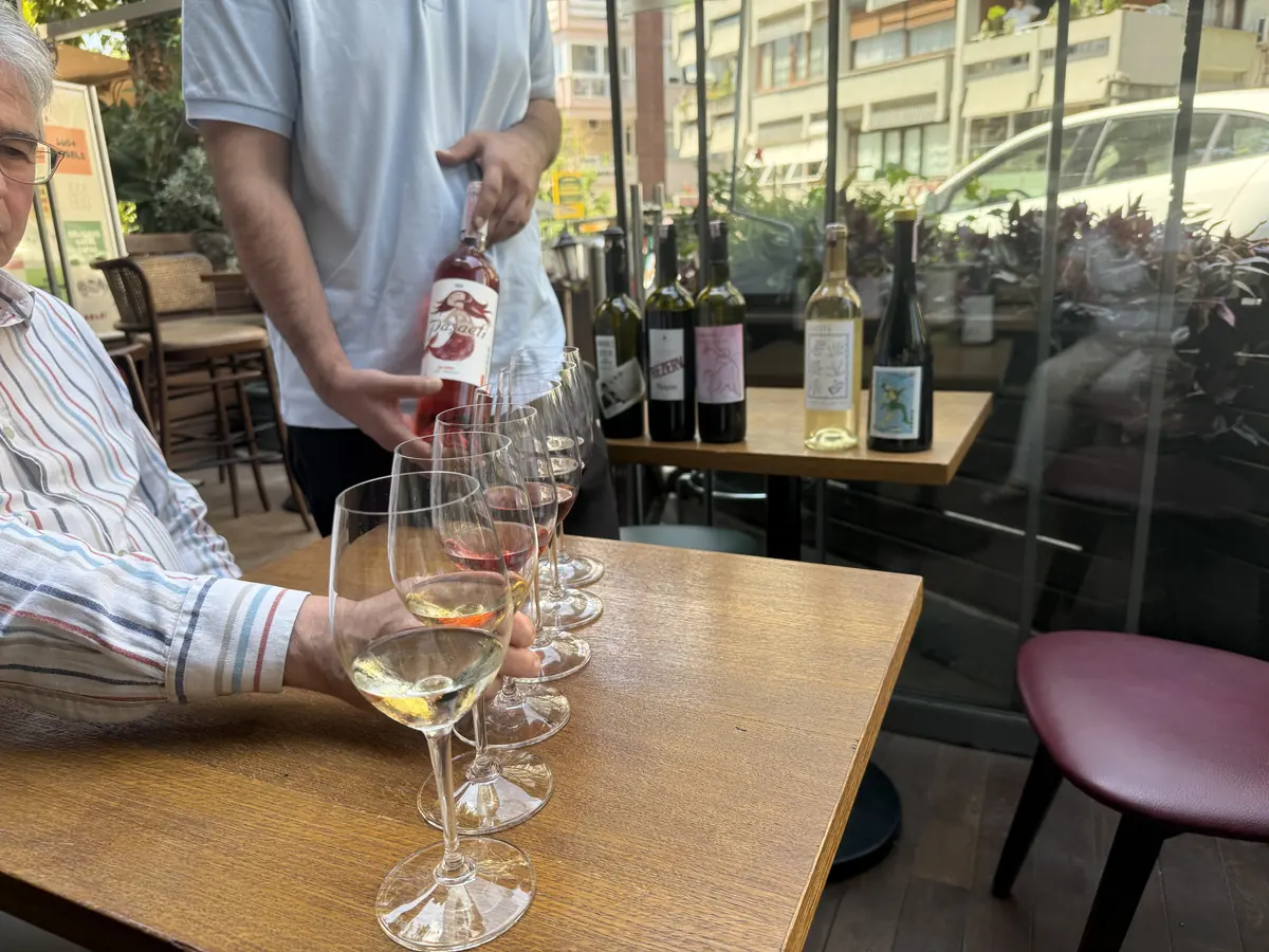 Sommelier pouring a flight of native Turkish wines for guests at WAYANA Wine Bar in Moda, Kadıköy