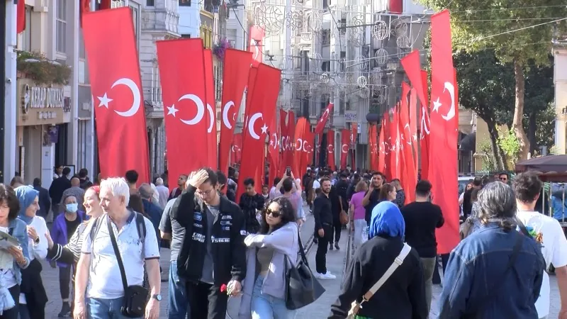 Crowds walking beneath rows of Turkish flags on İstiklal Avenue during the Republic Day celebrations of October 29